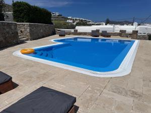 a swimming pool with a frisbee on a patio at Grace Villa Mykonos in Mikonos