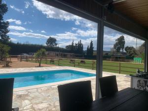 a view of a swimming pool through a window at Rancho Catalan 2 in Castillo de Aro