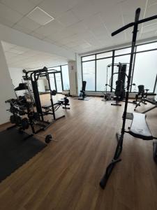 a gym with several tread machines in a room at Resident aparments two bed with balcony in Bucharest