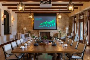 a conference room with a large table and a screen at Chateau Okanagan in Kelowna