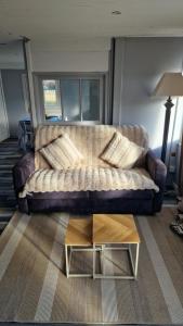 a living room with a couch and a coffee table at Chalet in Saint-Anthème