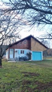 a barn with a picnic table in front of it at Chalet in Saint-Anthème