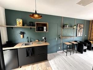 a kitchen with a sink and a counter top at Alice's Studio and Oasis in Poitiers
