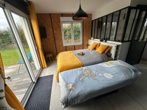 a bedroom with two beds and a large window at Alice's Studio and Oasis in Poitiers