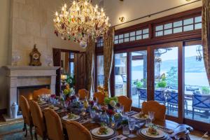 a dining room with a table and a chandelier at Chateau Okanagan in Kelowna +13 photos