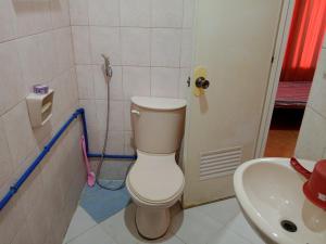 a bathroom with a toilet and a sink at Felipenas Lodging House in Matalom