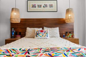a bedroom with a large bed with two lamps at Costa Dorada - Beachfront Penthouse in Bucerias Golden Zone in Bucerías