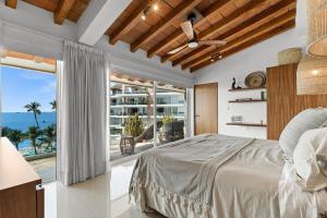 a bedroom with a bed and a view of the ocean at Costa Dorada - Beachfront Penthouse in Bucerias Golden Zone in Bucerías