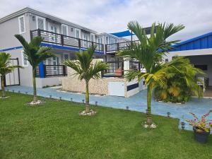 a row of palm trees in front of a building at 2 PALMAS STR in Aguadilla