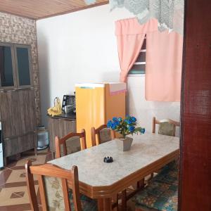 a kitchen with a table with a box on it at Aluguel Nova Tramandaí in Tramandaí +2 photos