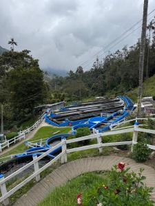 a group of blue water slides on a hill at Cabañas Valle del Cocora La Truchera in Salento