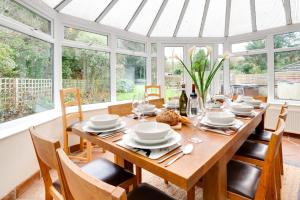 a dining room with a table with chairs and windows at 5 Bed in Croyde oc-brambc in Croyde +17 photos