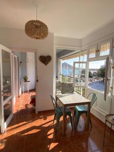 a dining room with a table and chairs and a balcony at Ocean Breeze & View Médano in El Médano