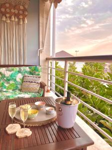 a balcony with a table and glasses of wine at Ocean Breeze & View Médano in El Médano