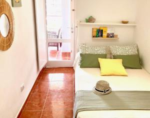 a small room with a bed with a hat on it at Ocean Breeze & View Médano in El Médano