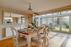 a dining room with a table and chairs and a mirror at 4 Bed in Westleton oc-s27303 in Westleton