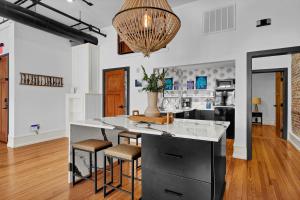 a kitchen with a large island with stools at Luxe 220 Suite 1 in Wilmington