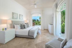 a white bedroom with a bed and a bathroom at Sugar Hill Resort, Bananaquit in Saint Joseph +44 photos