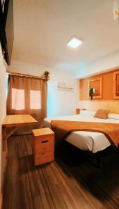 a bedroom with two beds and a wooden floor at Hotel Hito in Vitoria-Gasteiz