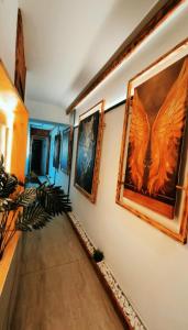 a hallway with paintings on the walls at Hotel Hito in Vitoria-Gasteiz +18 photos