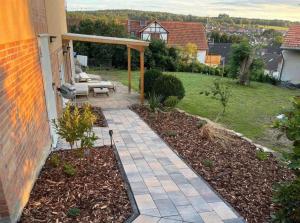 a backyard with a patio and a garden at Apartment am Grimmsteig in Nieste