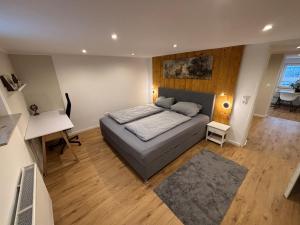 a bedroom with a bed and a desk in it at Apartment am Grimmsteig in Nieste
