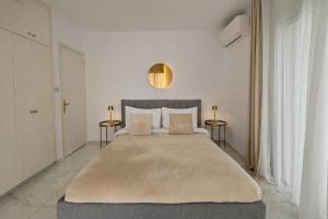 a bedroom with a large bed with two side tables at Beach Front View Apartment Sea Pool & Prime Location in Limassol +38 photos