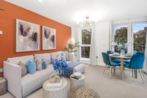 a living room with a couch and a table at Central Hemel 2-Bed Flat with Secure Parking in Hemel Hempstead