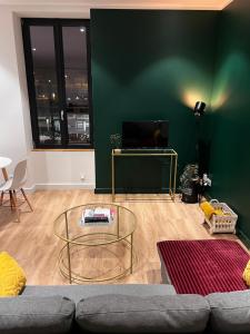 a living room with a couch and a glass table at L'arquebuse - Gare Dijon in Dijon