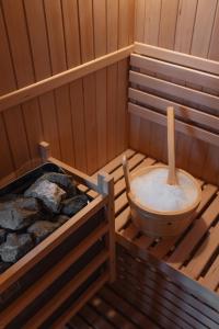 an inside of a sauna with a wooden tub at Agriturismo La Daga Nature Lodge in Auronzo di Cadore