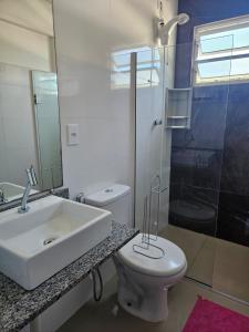 a bathroom with a sink and a toilet and a shower at Vila Sabará in Pinheiro +16 photos