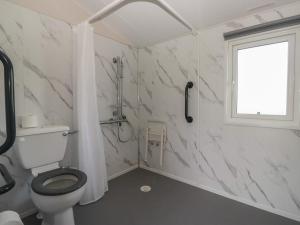 a bathroom with a toilet and a window at Guillemot in St Bees +29 photos