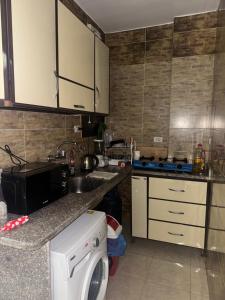 a kitchen with a sink and a washing machine at Safaga SeaView Rooftop in Safaga +25 photos