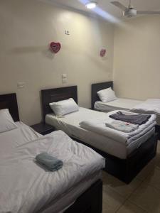 a room with three beds in a room at Safaga SeaView Rooftop in Safaga