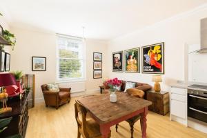 a living room with a table and a couch at Maitland House Boutique Apartment in Gloucestershire