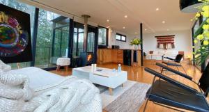 a living room with a white bed and a fireplace at Samadhi Eco Resort in Vilcún