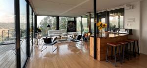 a living room with a bar and some chairs at Samadhi Eco Resort in Vilcún