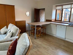 a kitchen with a table and a couch in a room at Oldcotes Studio in Firbeck