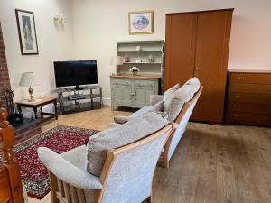 a living room with a couch and a tv at Oldcotes Studio in Firbeck