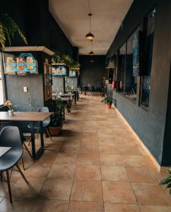 a dining room with tables and chairs and a tile floor at Hotel Integra Tepoztlán in Tepoztlán