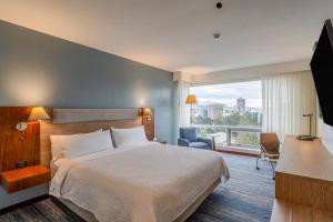 a hotel room with a bed and a large window at Holiday Inn Express Quito by IHG in Quito +95 photos