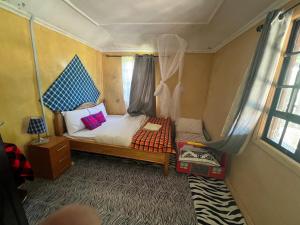 a small bedroom with a bed in a tent at leyianmaasaisafaris in Narok +14 photos