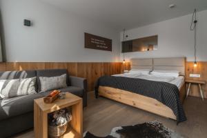 a bedroom with a bed and a couch at Valavier Aktivresort in Brand +62 photos