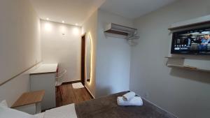 a room with a bed and a tv on the wall at Riviera Sanary 1206 - Nova Almeida in Serra +78 photos