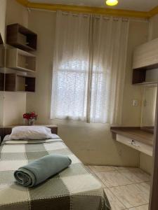 a bedroom with two beds and a window at Castelo Princesa Isabel in Ouro Preto