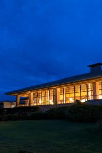 a large building with glass windows at night at Hotel Laforet Shuzenji in Izu