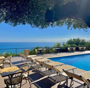 a row of tables and chairs next to a swimming pool at Villaggio Turistico La Fenosa in Marina di Camerota