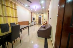 a dining room with a table and a couch at Azman in Fuvahmulah