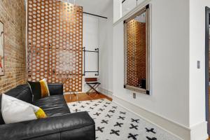 a living room with a black leather couch and a window at Luxe 220 Suite 5 in Wilmington +118 photos