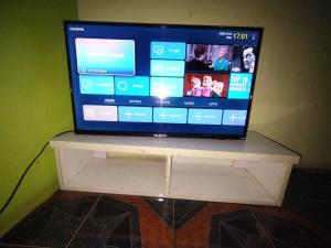 a television sitting on top of a white stand at Classic Hotel by TWM in Ibadan +47 photos
